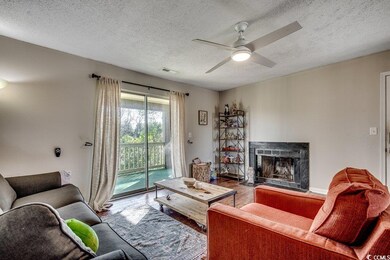 Living room featuring visible vents, a fireplace w