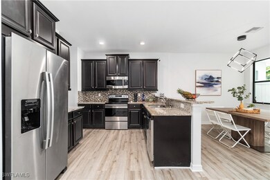 Kitchen featuring light stone countertops, sink, s