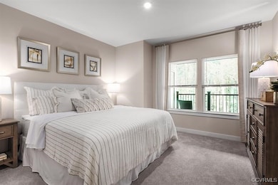 Carpeted bedroom featuring baseboards