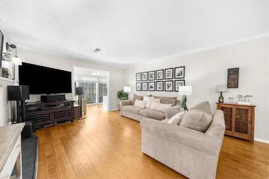 Living room with ceiling fan, ornamental molding, 