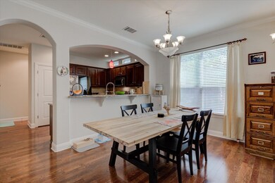 Dining space featuring dark wood-style floors, ar