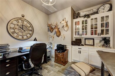 Spacious study with built in cabinets.