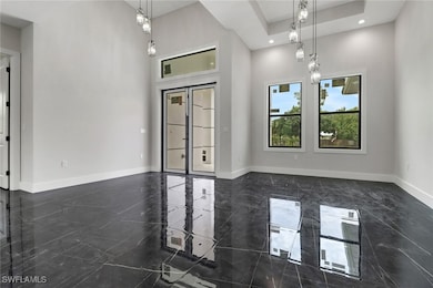 Entry featuring a high ceiling, tile flooring, and