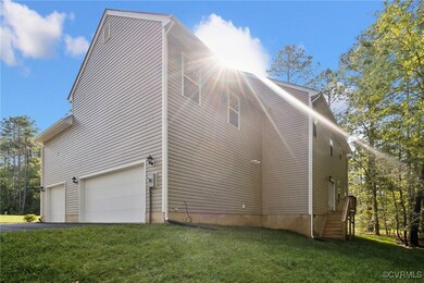 View of property exterior featuring a garage and a
