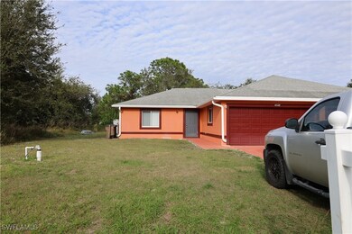 Ranch-style house featuring a garage, a front yard