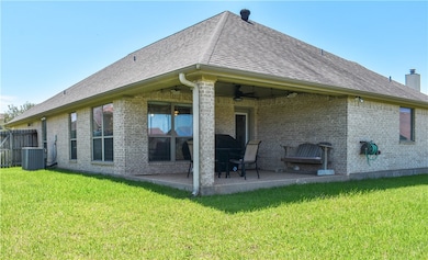 Rear view of property featuring a ceiling fan, a p
