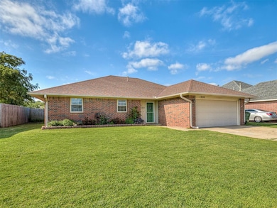 Single story home with a front yard and a garage