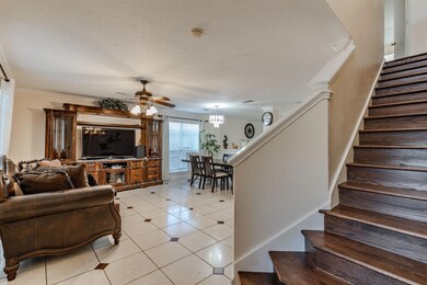 Tiled living room with a textured ceiling, ornamen