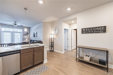 Kitchen featuring light stone counters, stainless
