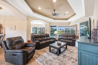 Living room with ceiling fan, light tile patterned