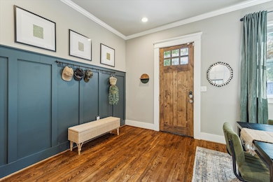 The entry way features custom molding and opens to