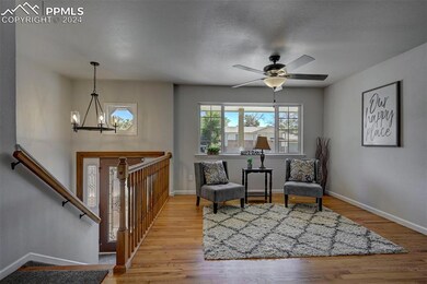 Living area featuring ceiling fan with notable cha