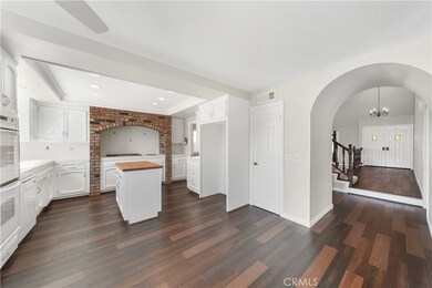Bright, open kitchen with butcher block island and brick accents