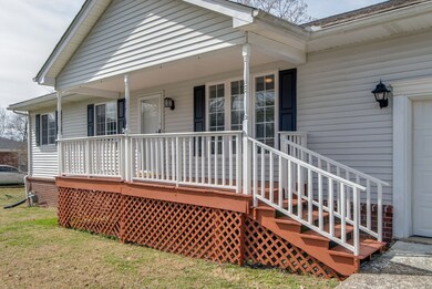 The quaint covered front porch greets guests as they arrive. 