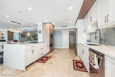 Kitchen with a sink, white cabinets, stainless steel appliances, light countertops, and backsplash