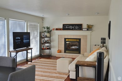 Living room featuring dark hardwood / wood-style floors and a tile fireplace