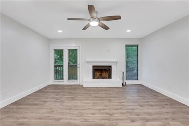 Unfurnished living room featuring a fireplace, baseboards, a ceiling fan, light wood finished floors, and recessed lighting