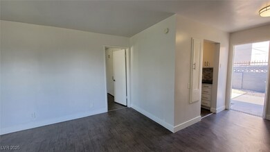 Spare room featuring dark wood-style flooring and