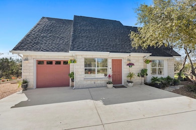 View of front of property with concrete driveway,