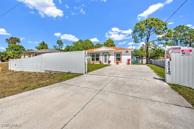View of front of house featuring driveway and fenc