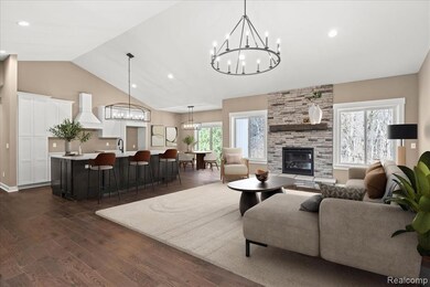 Living room with dark wood finished floors, a fireplace, a chandelier, recessed lighting, and high vaulted ceiling