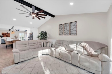 Living room featuring recessed lighting, wood finished floors, ceiling fan, and beverage cooler