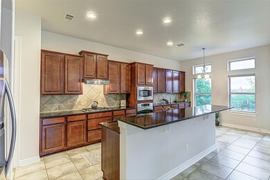 Kitchen with a center island with sink, appliance