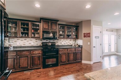 Tile back splash ties right into the elegant look! Don't forget the double oven!