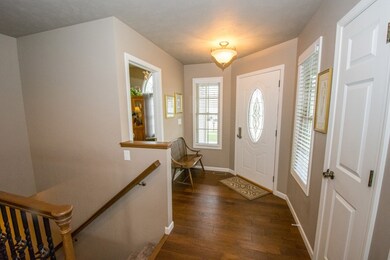 Foyer with open staircase to basement.