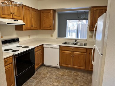 Kitchen featuring white appliances and sink