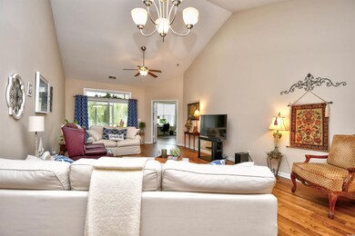Living room with high vaulted ceiling, ceiling fan