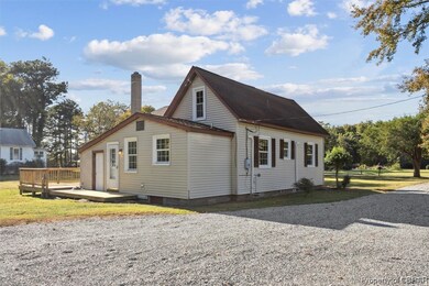 View of side of property featuring a wooden deck