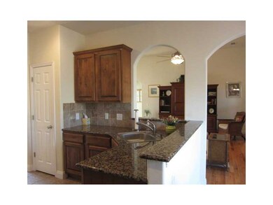 Kitchen. beautiful granite counters, pantry area, tile backsplash.