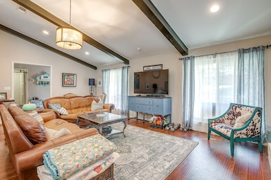 Living area with wood finished floors and recessed lighting