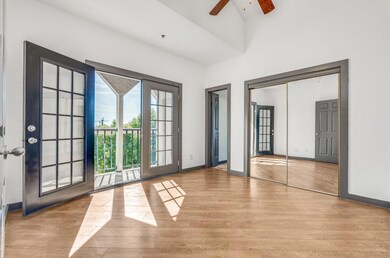 Unfurnished bedroom with a high ceiling, access to