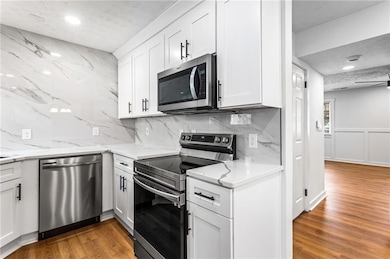 Kitchen featuring light wood finished floors, appl