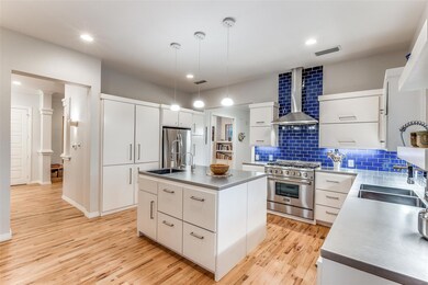 Chef's kitchen with island, vegetable sink, and lo