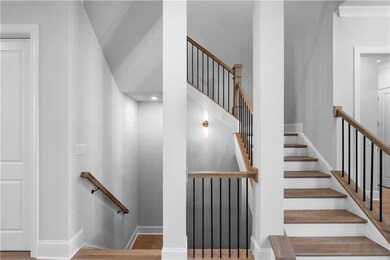 The grand open rail staircase serves as a stunning focal point in the home, making an immediate impression with its elegant design.