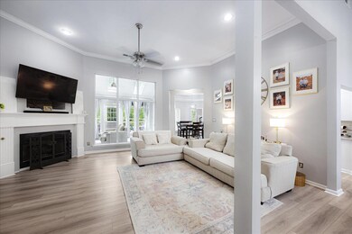 Living room with ceiling fan, light wood-type floo
