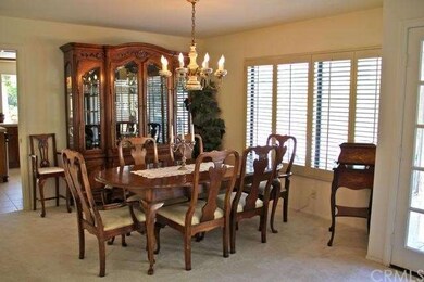 Elegant formal dining room with wood shutters and 