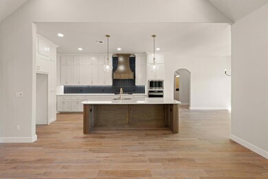 Kitchen with white cabinets, hanging light fixture