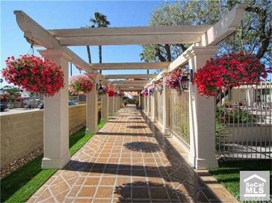 The flower lined loggia leads you to the resort-st