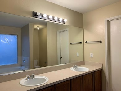Bathroom with a bath to relax in, toilet, double s