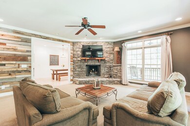 Living room has floor to ceiling stone wood-burning fireplace. Natural light floods in from the windows that surround the 1st floor. Enjoy the views year round! 9 ft ceilings throughout the first floor!