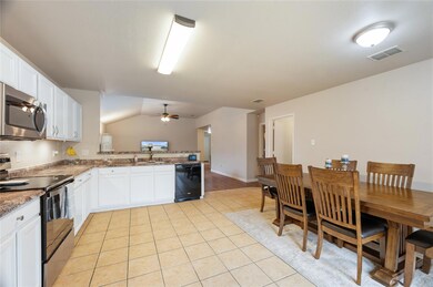 Beautiful granite counters and white cabinets.