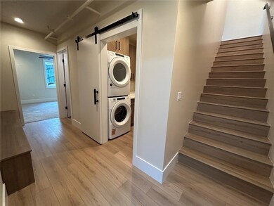 Laundry room featuring estacked washer and dryer,