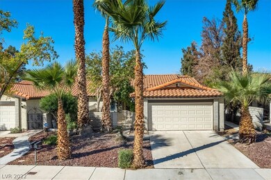Front of the property features mature and desert l