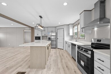 Kitchen with a kitchen island, wall chimney exhaus
