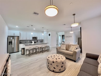 Living area with light wood-style floors and reces