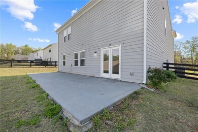 Back of house with a fenced backyard and a patio